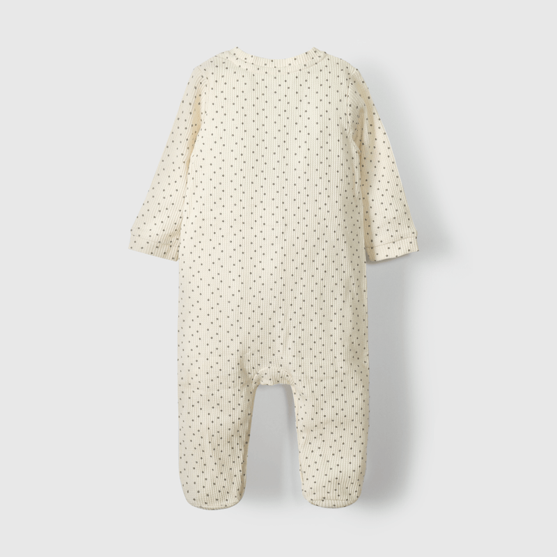 Enterito beige suave para guagua con puntos de diseño tierno